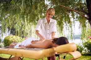 Massage - woman receiving back massage in nature